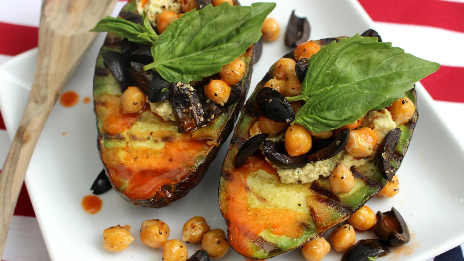 grilled avocado stuffed with Toby's plant based dip & spread, chickpeas and olives