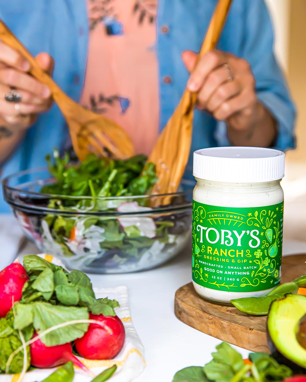 green salad being tossed with Toby's Ranch Dressing & Dip