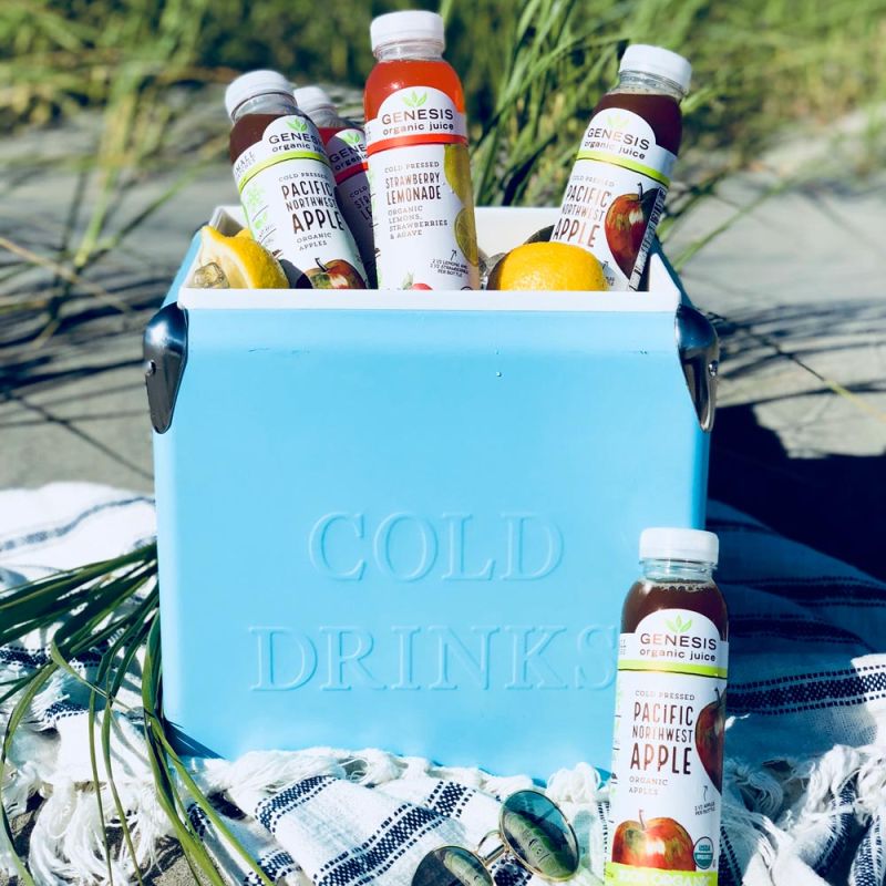 cooler filled with Genesis Organic Juices at the beach